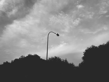 Low angle view of silhouette trees against sky