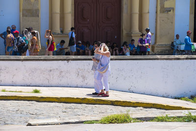 People standing on staircase outside building