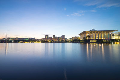 Tuanku mizan zainal abidin mosque by lake against sky