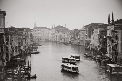 Boats in sea against buildings in city