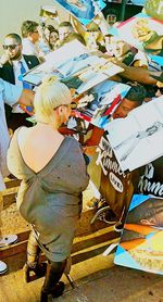 High angle view of people standing at market stall