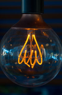 Close-up of illuminated light bulb