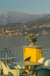 Yellow table by mountains against sky