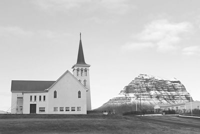 Monochrome image of church of grundarfjordur town with the famous kirkjufell mountain, iceland