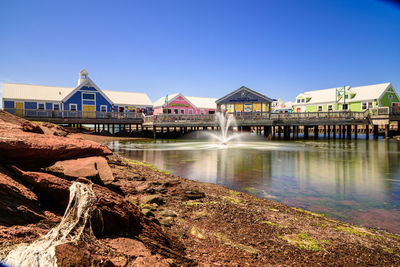 View of buildings against clear blue sky