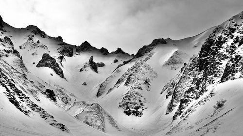 Scenic view of snow covered mountains against sky