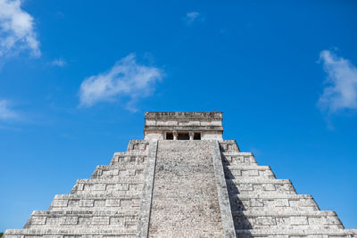 Low angle view of chichen itza against blue sky