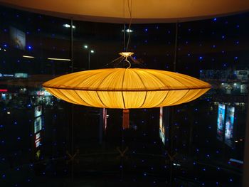 Close-up of illuminated yellow lights hanging at night