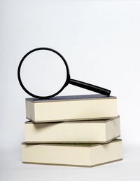Close-up of books on table against white background
