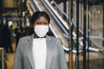 Mature female entrepreneur with protective face mask at subway station