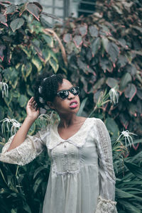 Portrait of young woman in plant