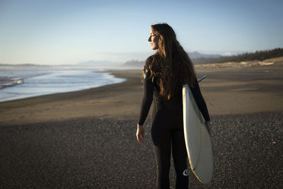 Surfer girl on the beach near tofino