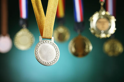 Close-up of medals against blackboard