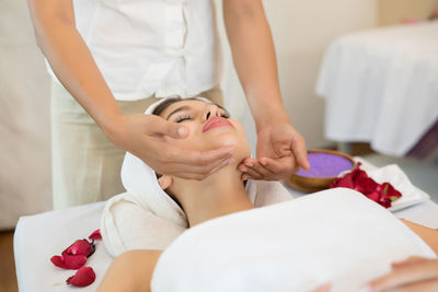 Midsection of woman lying on bed