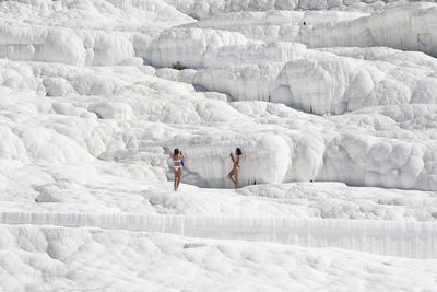 People skiing on snow covered field