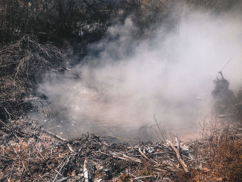 Smoke emitting from water on land