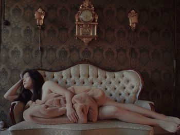 Woman lying down on sofa