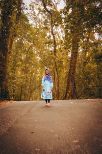 Rear view of woman walking on road