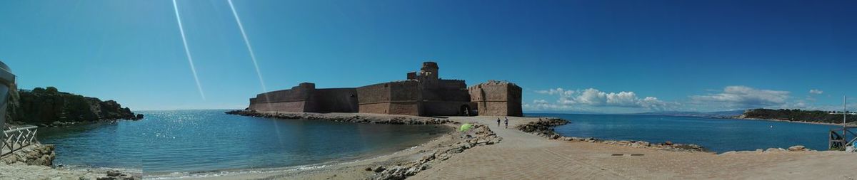 Panoramic view of sea against blue sky