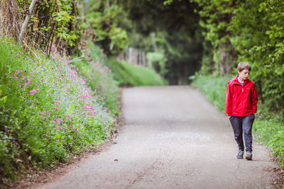 Full length of boy walking on road