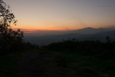 Scenic view of silhouette mountains against sky at sunset