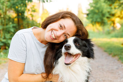 Portrait of woman with dog outdoors
