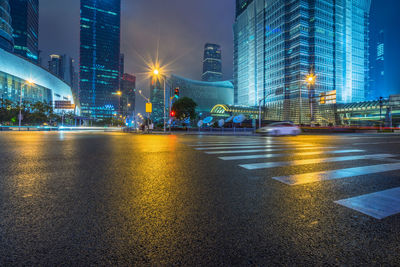 Illuminated city street and buildings at night