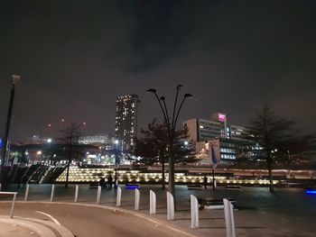 Illuminated city against sky at night