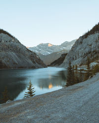 Scenic view of lake and mountains against clear sky