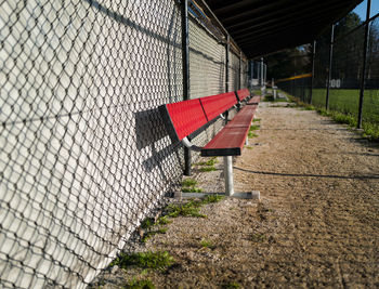Empty red baseball dugout bench