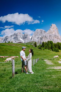 Woman standing on field against sky