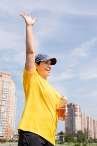 Low angle view of woman standing against the sky