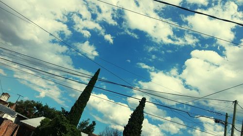 Low angle view of electricity pylon against sky