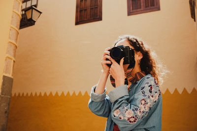 Woman photographing with camera