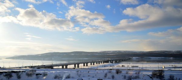 Panoramic view of snow covered trees against sky