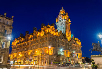 Low angle view of illuminated building against sky at night