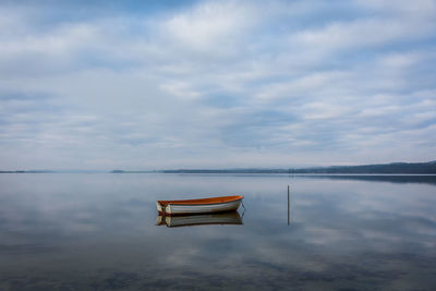 Boat on lake against sky