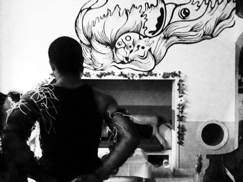 Close-up of woman standing against wall