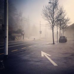 Car parked at roadside with arrow symbol in foggy weather