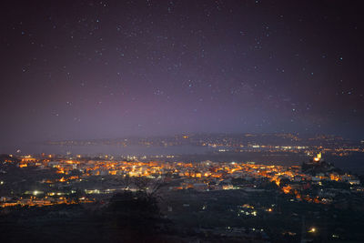 High angle view of illuminated buildings in city at night