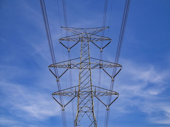 Low angle view of electricity pylon against sky