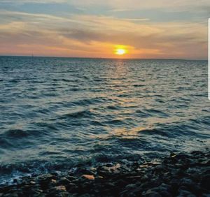 Scenic view of sea against sky during sunset