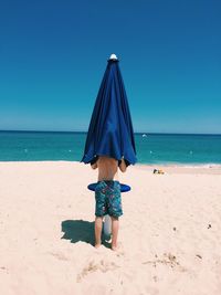 Scenic view of beach against blue sky