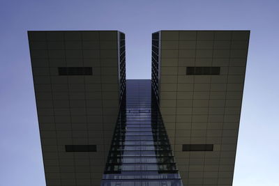 Low angle view of modern building against clear blue sky