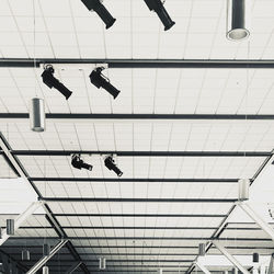 Low angle view of people hanging on wall in building