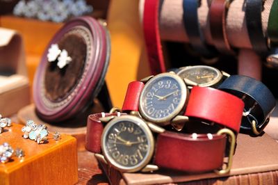 Close-up of various wristwatches for sale at market stall
