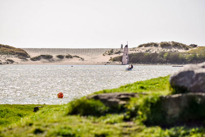 Sailboat in marina against blue sky in crosby, liverpool 