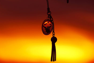 Close-up of pendant hanging against abstract background