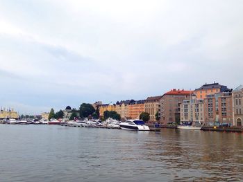 Boats in river with buildings in background