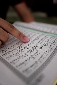 Close-up of hand holding book